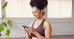 Woman, phone and texting with smile at gym with fitness, contact and excited for notification at studio. Person, smartphone and happy with scroll, mobile app or social network post at wellness club