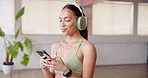 Smartphone, fitness and woman in studio, headphones and song with wellness, radio or audio. Album playlist, exercise or healthy person with cellphone, sound or listening to music, workout and app