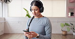Cellphone, fitness and woman in studio, headphones and radio with wellness, podcast or audio. Song, exercise or healthy person with smartphone, sound or listening to music, workout or playlist album