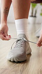Exercise, hands and woman tie shoes at health club to start workout, fitness preparation or practice. Wellness, person and sneakers in studio for training comfort, physical activity and getting ready