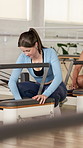 Pilates, machine and woman with springs for reformer adjustment for exercise, workout and fitness. Health club, class and people with equipment to practice for wellness, resistance and active hobby