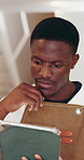 Small business, tablet and thinking with designer black man in workshop for planning or research. App, creative and design with thoughtful African employee in studio for feedback, review or update