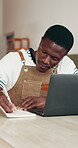 Writing, laptop and notebook with black man in cafe for menu planning, entrepreneur or delivery schedule. Barista invoice, digital inventory and small business with person in coffee shop for catering