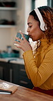 Coffee, dance and headphones with woman in kitchen of home for remote work or small business. Caffeine, cup and music with happy freelance employee drinking beverage in apartment for startup job