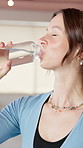 Yoga, drinking and woman in studio with water for hydration, wellness and recovery after exercise. Happy, pilates center and person with liquid, minerals and vitamins for health, break and rest
