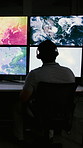 Back, man and screen with satellite in control room to monitor weather, climate change and maps. Meteorologist, computer and headset with hurricane surveillance, study storm pattern and track cyclone