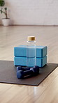 Yoga, empty and dumbbells in studio on floor for workout routine, exercise and fitness class. Background, health club and equipment, water bottle and weights on mat for wellness, pilates and gym