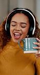 Coffee, dance and music with woman in home for break, relax or wellness on weekend morning. Energy, headphones and streaming with happy person drinking beverage in apartment for caffeine or me time