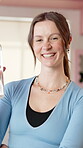 Gym, water bottle and face of woman for fitness, exercise and training in health club. Smile, portrait and female person with drink, confidence and support for personal trainer studio and growth