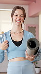Woman, face and smile at gym with yoga mat, water and confidence at pilates class for wellness. Girl, happy and excited in portrait with bottle, gear or exercise equipment at health club in Australia