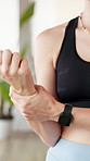 Wrist pain, stretching and hands of woman in gym for exercise, pilates and yoga for wellness. Studio, active and person with strain, tension and joint ache for workout injury, health and accident