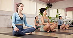 Woman, yoga and group on floor at gym with breathing, eyes closed and awareness with zen in class. People, easy pose and meditation with mindfulness, self care or peace on mat at for wellness club