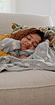 Woman, sleeping and blanket on couch at house for rest, afternoon nap and exhausted of long day. Fatigue, female person and lying on sofa for weekend peace, asleep and dreaming for wellness in lounge