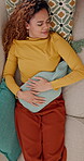 Above, menstruation and woman on sofa with hot water bottle, sleep and stomach ache in symptoms. Health, fatigue and girl in house with heat bag, endometriosis and soothe abdominal pain on cycle.