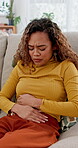 Stomach, ache and pain with woman on sofa for ibs symptoms, digestive issue and bloating. Gastrointestinal cramps, ulcer and indigestion with female person in living room of home for appendicitis