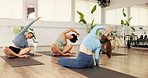 Stretching, yoga and women in class with trainer for exercise, wellness and practice for flexibility. Gym, fitness club and people with instructor in pilates lesson for balance, health and wellbeing