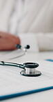 Stethoscope, clipboard and information with people at doctors office for medical records, registration and sign. Documents, life insurance and healthcare with person at clinic for assessment form