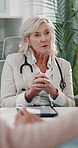 Doctor, woman and talk with couple at fertility clinic with advice, holding hands and support in office. Mature person, patient and partner with tablet, consulting or explain ivf process at hospital