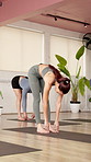 Fitness, yoga or women in gym with stretching, mobility or forward bend in body practice. Uttanasana, wellness or people in studio with support, balance or spinal improvement in pilates club.