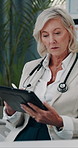 Pen, doctor and mature woman with tablet for schedule, healthcare report and telehealth. Technology, stylus and medical professional reading email, review records or planning research in hospital
