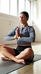 Woman, namaste pose and meditation on floor at gym for breathing exercise, peace or eyes closed at class. Girl, yoga and prayer hands with mudra, zen and awareness routine in morning at wellness club