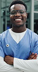 Face, happy man and doctor in hospital with arms crossed for healthcare job, service and growth. Black person, pride or nurse in clinic with smile for medical internship, patient support or about us.