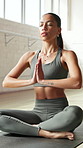 Meditation, stretching and yoga with woman in studio for holistic exercise or mindfulness. Awareness, balance and inner peace with yogi person on floor for breathing, mental health or wellness
