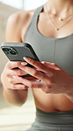 Hands, phone and texting on floor at gym, contact and scroll on break with web chat at pilates class. Person, smartphone and typing on mobile app, social media or search fitness tips at wellness club