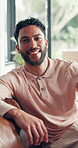 Property, face and man on sofa with smile, fresh start and investment in dream house. Real estate, portrait and happy male in home with success, relocation and mortgage plan for new homeowner.