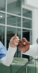 Emergency, hands with fist bump and people in hospital for healthcare, ambulance bay and night. Overtime team, trauma center and ems director with doctors in clinic for accident support and icu
