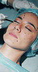 Woman, plastic surgery and drawing on face at clinic, hands and process for beauty transformation. People, doctor and patient with pen, lines and procedure for cosmetic enhancement on hospital bed