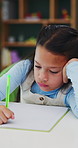 Development, education and notebook with girl student in home study for growth or learning. Homework, knowledge and writing with child pupil at desk in apartment for academics or school assessment
