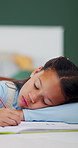 Class, sleeping and child with book for education, tired student and school activity for knowledge. Learning fatigue, mental exhaustion and girl resting with pen, nap and development in lesson.