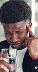 Headache, tension or black man in office with water, electrolytes or pain at workplace. Bokeh, migraine or employee in agency with cold beverage, dehydration prevention or pressure in job stress.
