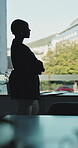 Business, woman and arms crossed at window in office for architecture, career ambition and buildings. Architect, vision and property development, urban infrastructure and city view for town expansion
