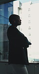 Thinking, woman and arms crossed at window in office for architecture, career ambition and buildings. Below, architect and property development, urban infrastructure and reflection for town expansion