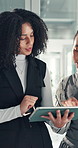 Team, tablet and business women talk in office for research, copywriting feedback or help. Technology, collaboration or planning in meeting for project, blog review or brainstorming ideas for article