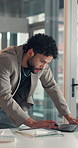 Tablet, laptop and businessman with documents in office with planning for finance report. Computer, digital technology and male financial manager with paperwork for investment proposal in workplace.