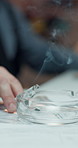 Smoking, detective and hands with cigarette in office for stress, crime investigation and nicotine. Smoker, police officer and person with ashtray on desk, planning or problem solving with evidence