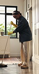 Housework, sweeping and black woman in home with broom, dirt prevention and removal in domestic chores. Hygiene, cleaning and girl in kitchen with gloves, sanitation and maintenance for floor care.