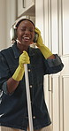 Headphones, singing and black woman with broom in kitchen, home maintenance or listen to music. Spring cleaning, streaming radio and happy person with audio tech for housekeeping, hygiene or karaoke