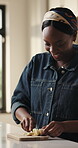 Banana, cutting and breakfast with black woman in kitchen for nutrition, organic and fruit. Wellness, diet and morning meal with female person eating in home for healthy food, vitamins and snack