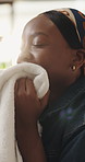 Woman, smell laundry or towel in home with spring cleaning for fabric scent, maintenance or hygiene. Flare, black person or cloth in apartment with detergent fragrance, soft material or housekeeping.