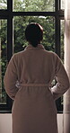 Morning, reflection and woman at resort with window view, gratitude and thinking on holiday trip. Back, relax and female person in bedroom with new day, travel and calm on beginning of vacation.