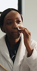 Black woman, bathroom and mirror with cotton pad for skincare, beauty and facial cleanse in home. Morning routine, dermatology and African person with patch for cleaning, grooming and makeup removal
