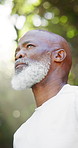 Thinking, fitness and mature black man in park to start exercise, training and workout for health. Nature, reflection and low angle of person outdoor rest for wellness, active hobby and wellbeing