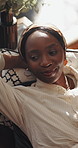 Relax, thinking and black woman in lounge, above and smile with ideas, resting and remember. House, calm and African person on couch, decision and daydreaming with wonder, memory and weekend break