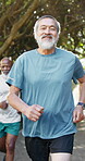 Face, old man and running in park for fitness, exercise challenge and wellness with healthy body. Happy, elderly person outdoor and jog with health club, cardio workout and endurance training goals.