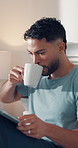 Coffee, reading and tablet with man in bedroom of home for me time, morning break or wellness. App, caffeine and ebook with person drinking beverage on bed in apartment for hobby, literature or story