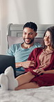 Couple, laugh and relax in bed with laptop, happy and choice for streaming movies, series or show in home. Man, woman and smile for discussion in bedroom, bonding or film subscription at apartment